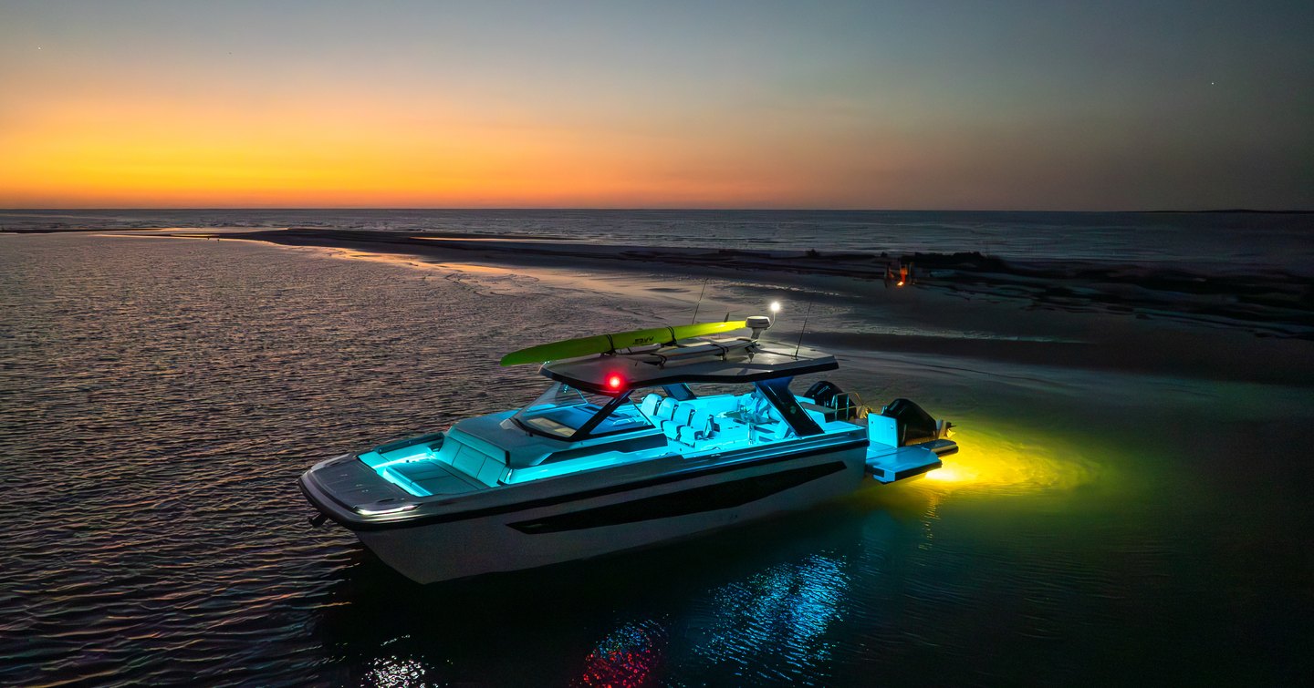 Aquila 45 Sport powercat at anchor at sunset with underwater lights and open deck layout, highlighting dayboat and sandbar use