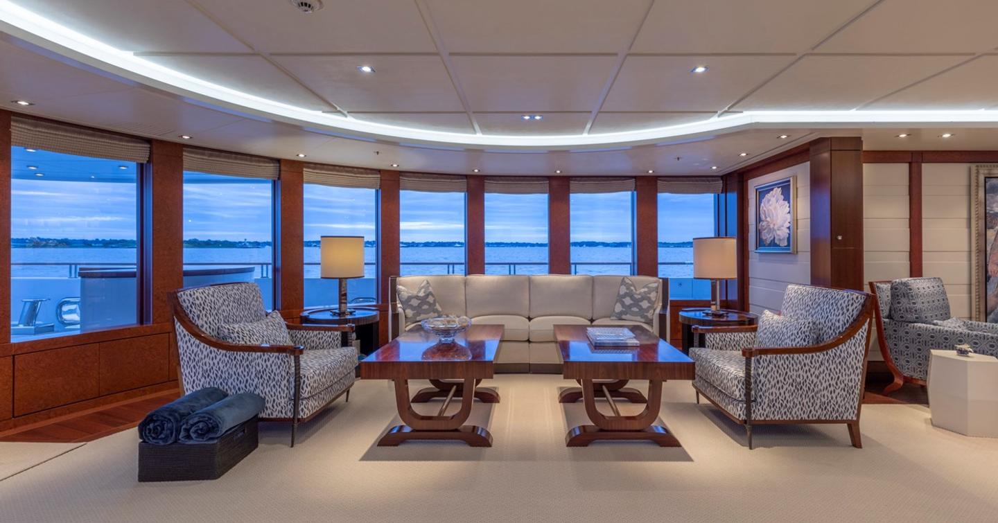 Superyacht Bella Vita's interior seating with coffee table and large windows