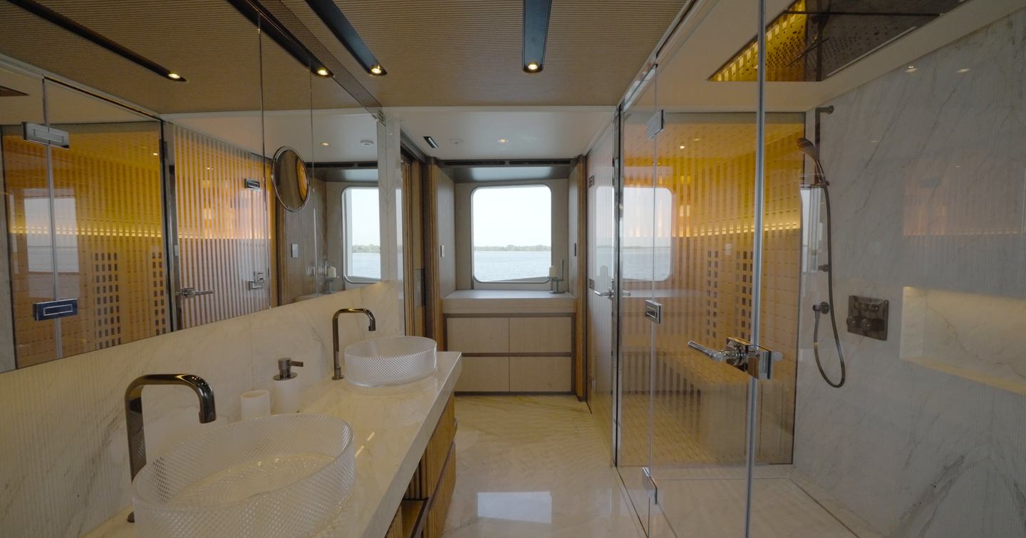 Owner's ensuite aboard the Gulf Craft Majesty 145 with twin basins, infrared sauna and oversized shower