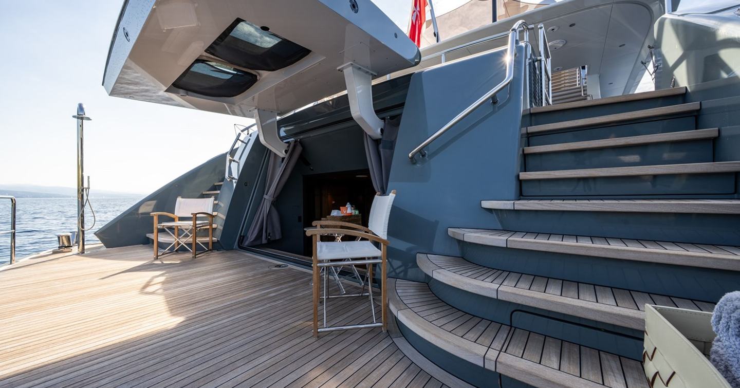 Superyacht Reliance beach club with hydraulic stern and deck chairs