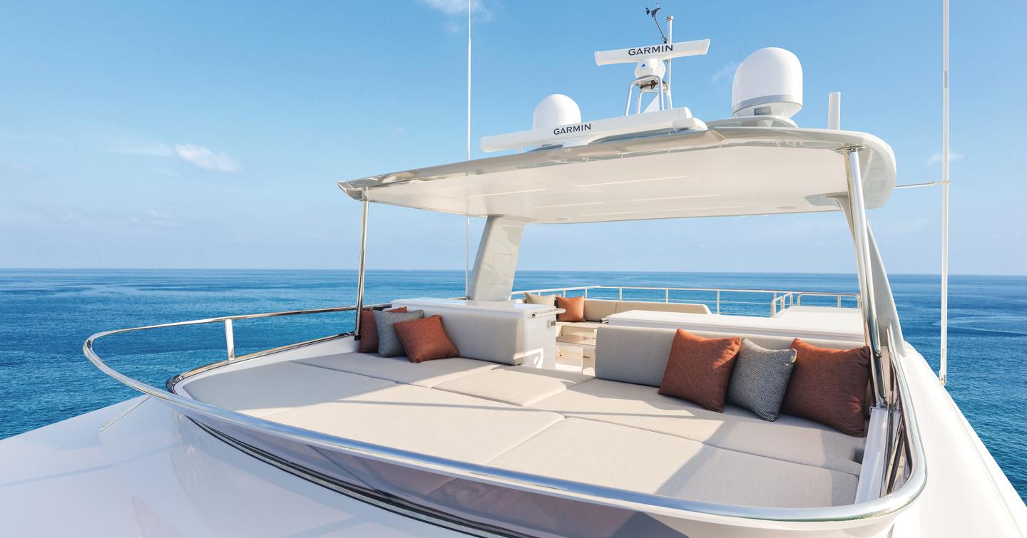 Seventh Horizon FD110 motor yacht upper deck with large beige sunpad and bar area 