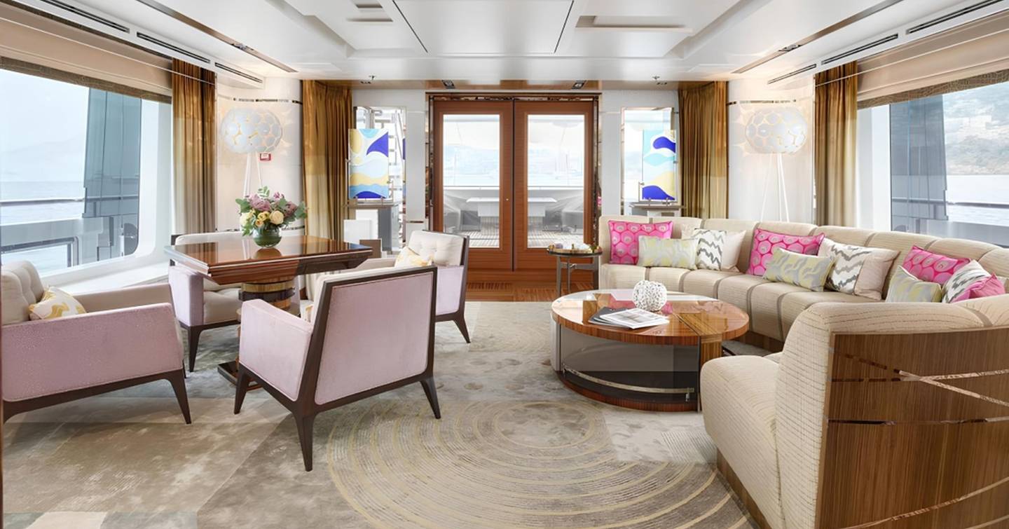 Superyacht Philosophy main saloon with pink furniture and curved seating 