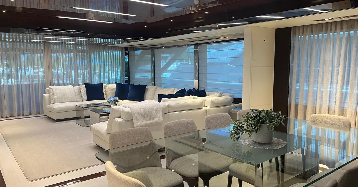 Superyacht Onyx's main saloon with U-shaped sofa and dining area