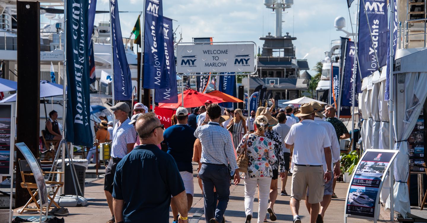 Visitors walking between lines of exhibitor stands at FLIBS