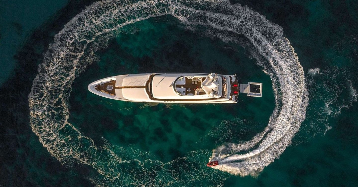 Hero shot of superyacht Envy with tender 