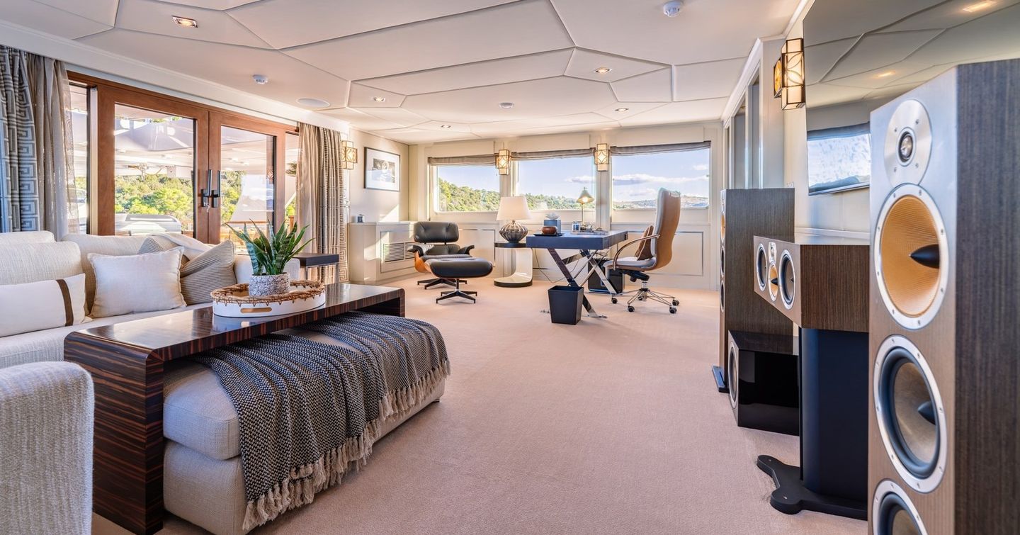 Superyacht Victory's skylounge with desk area, seating and speakers
