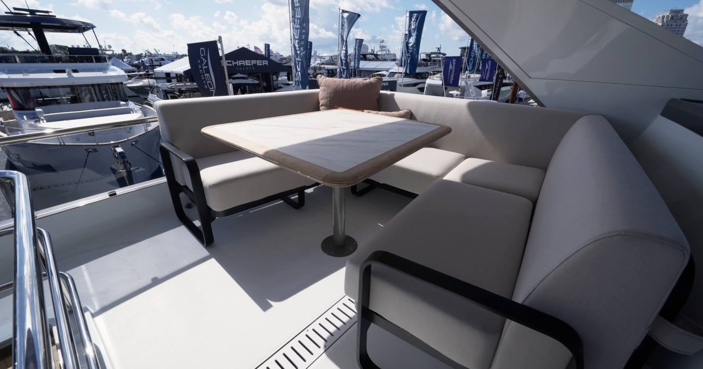 Galeon 520 Fly flybridge seating area with dining table and sheltered lounge layout