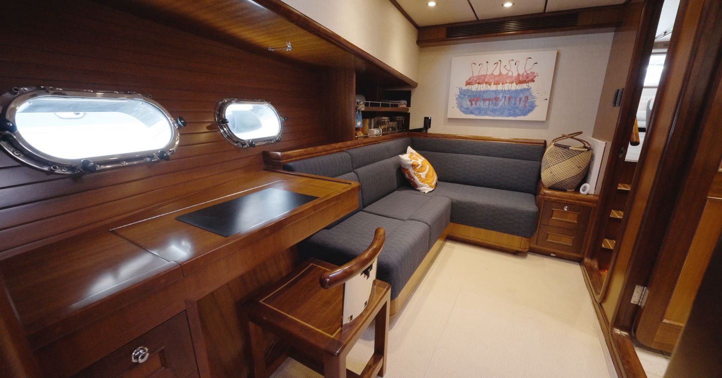 Nordhavn 75 EYF owner's suite lounge with desk, sofa and private sitting area