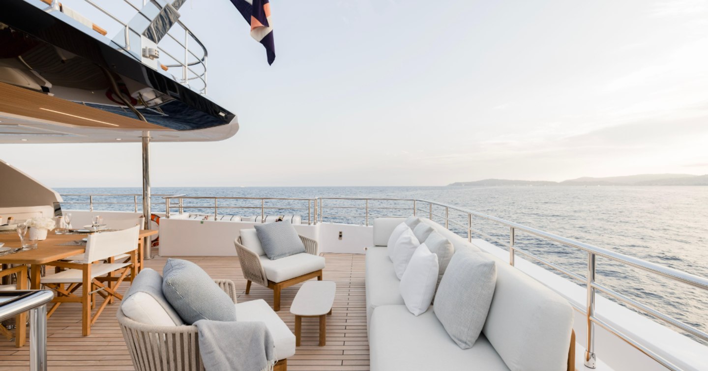 Superyacht Olivia aft deck with alfresco dining and grey furniture 