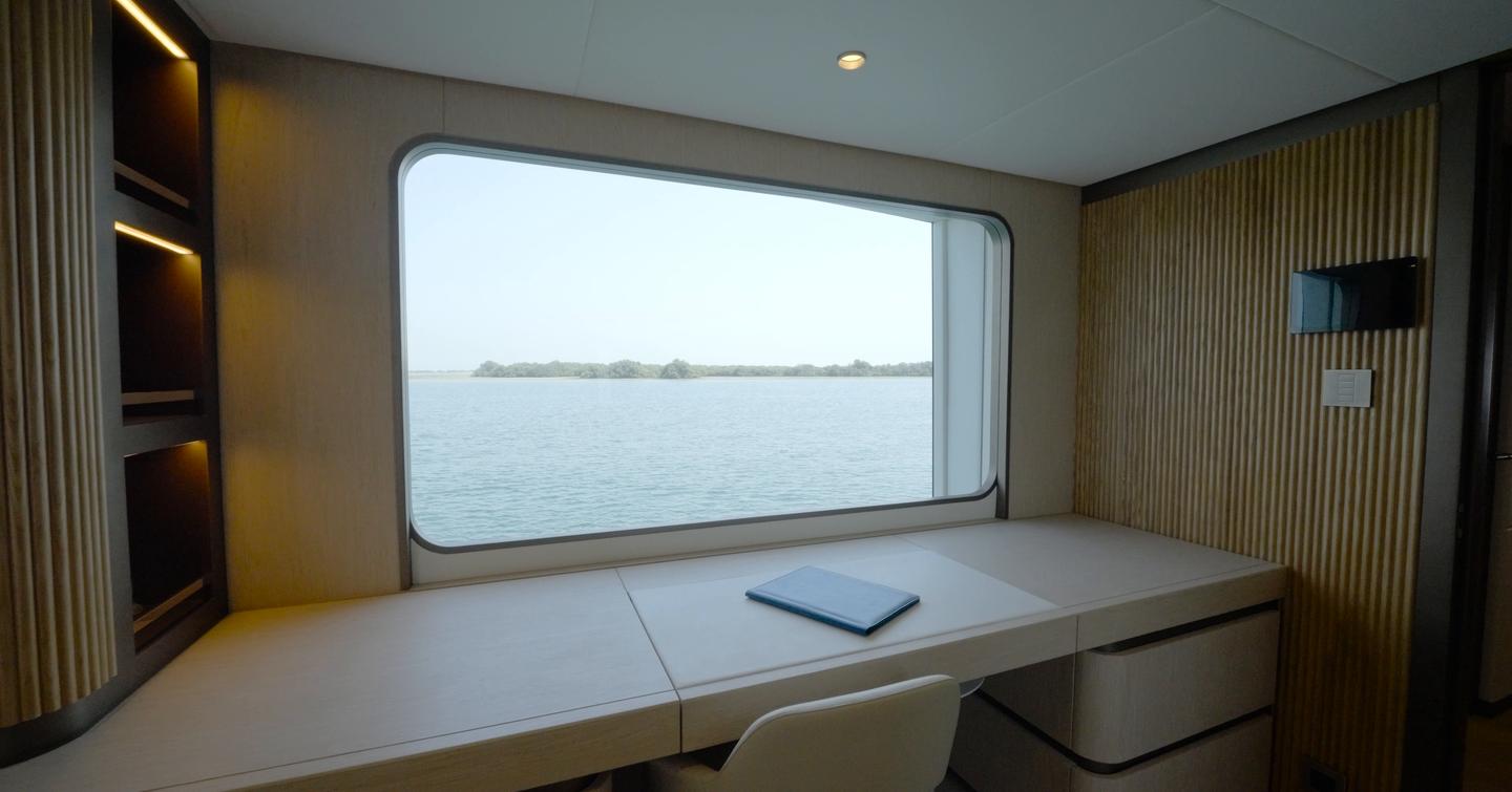 Forward-facing owner's desk in the Gulf Craft Majesty 145 owner's suite with sea views
