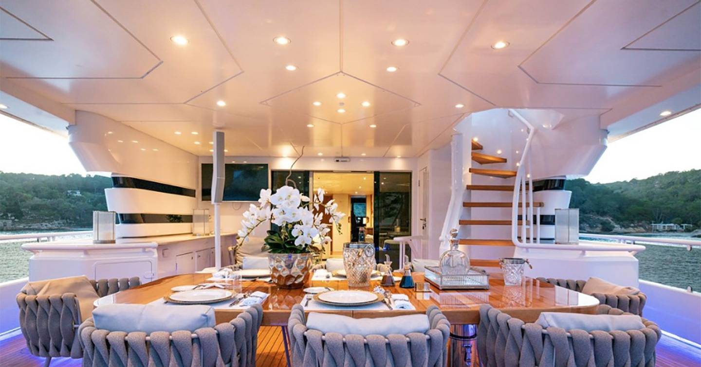 Superyacht Envy's aft dining shaded dining table 