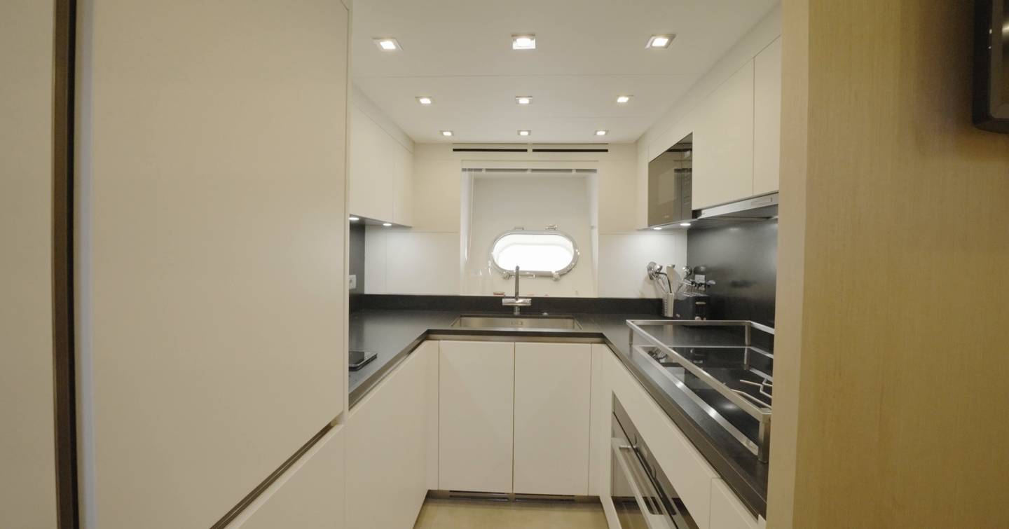 Crew galley on the Sanlorenzo SHE with white cabinetry and stainless worktops