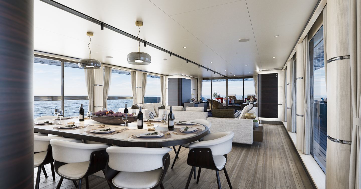 Main salon onboard Tankoa Yachts T500 Tethys. Formal dining area in foreground next to a wide stretching window, lounge area aft.