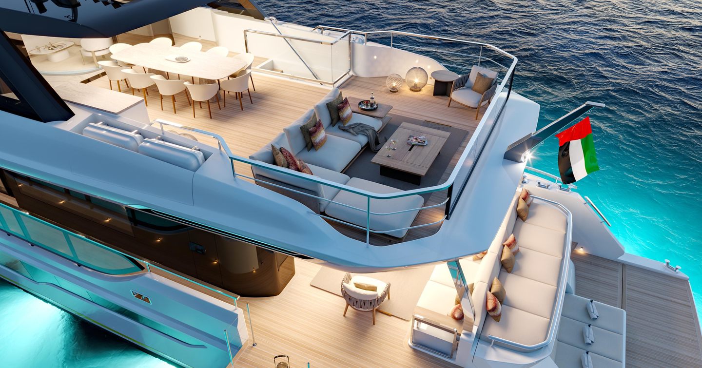 Gulf Craft's Majesty 100 Terrace motor yacht aft decks at night with underwater lights
