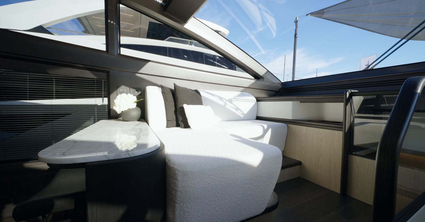 Pearl 73 forward saloon with seating next to lower helm station