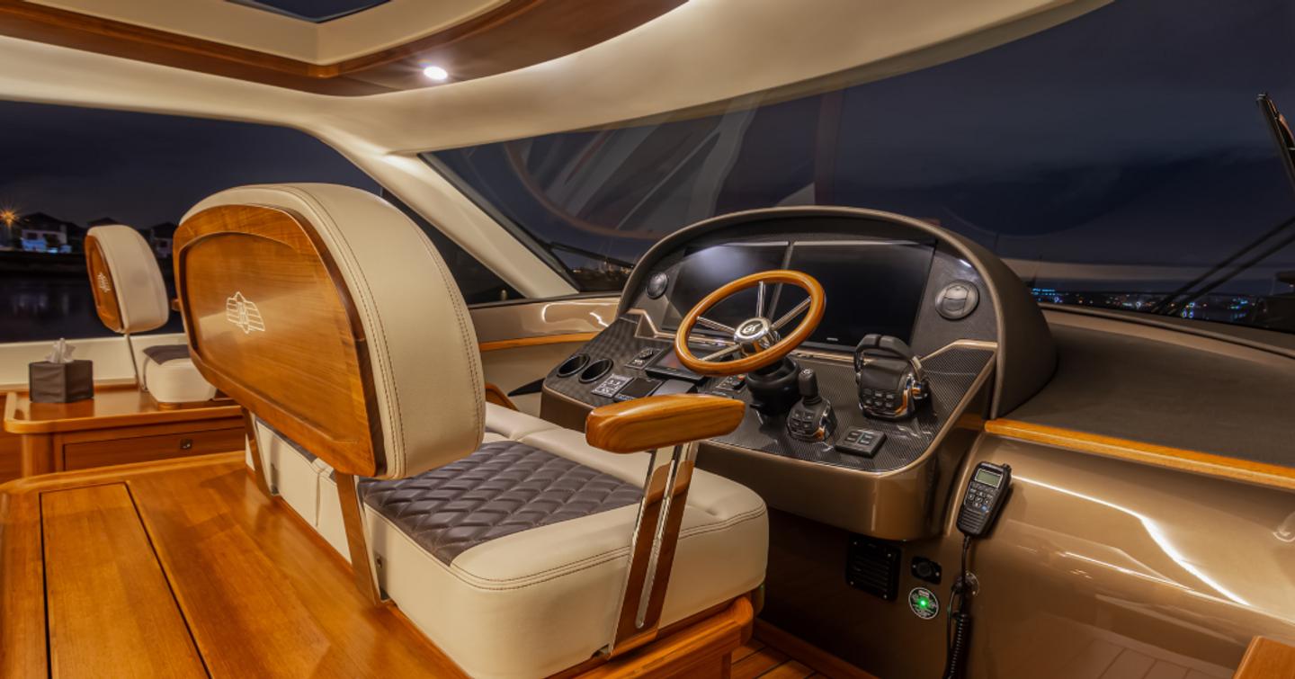 The helm onboard the GT60 is timeless, fusing woods and metals.