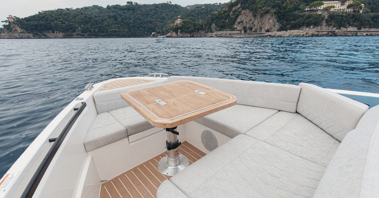 Saxdor 400 GTC boat foredeck with U-shaped seating and wooden table