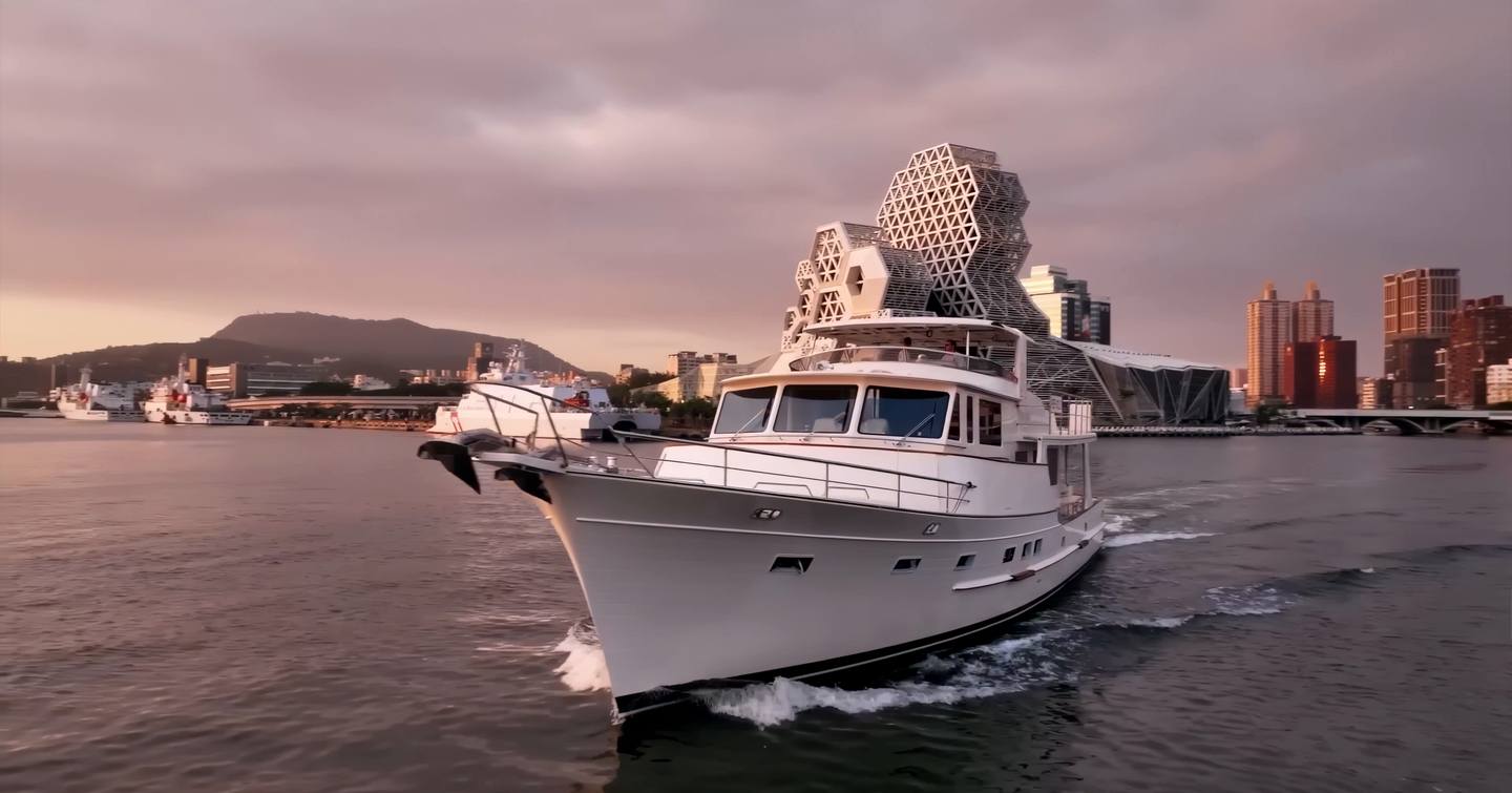 Fleming 85 long-range motor yacht underway with Portuguese bridge and open flybridge