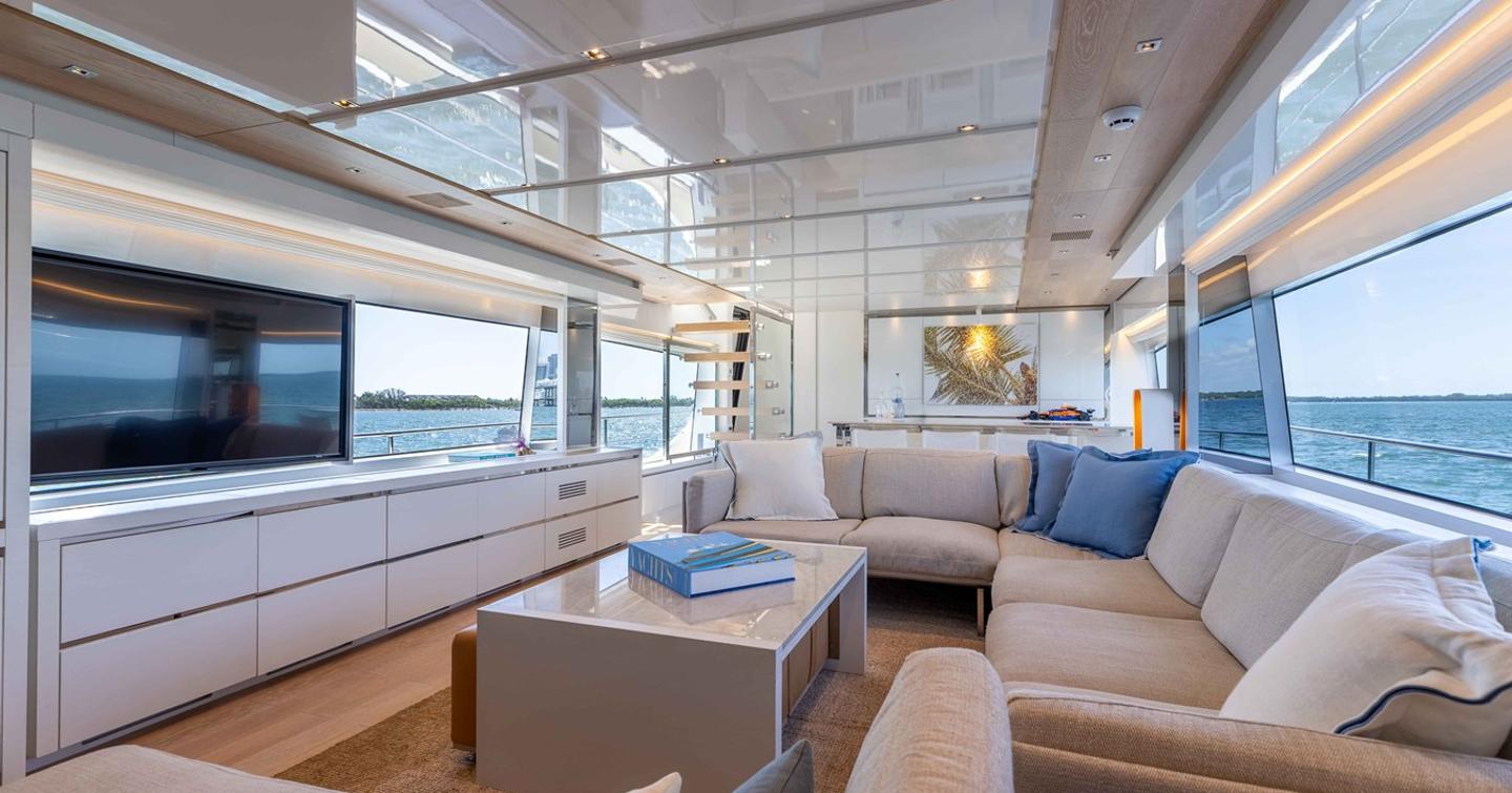Motor Yacht Sasa salon with mounted TV, L-shaped seating and dining area
