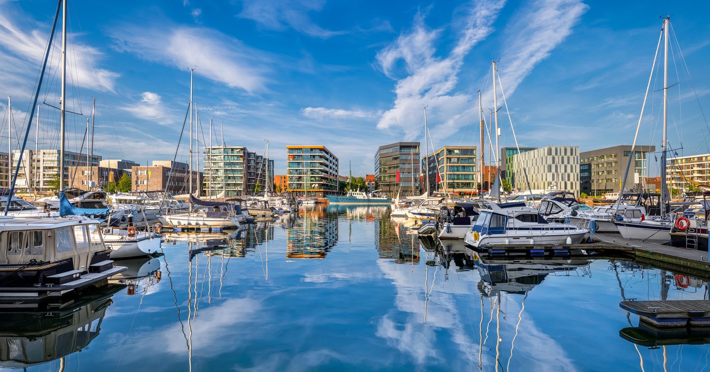 Overview of the harbour at Bremerhaven, Germany, with multiple sailing boats and motor yachts berthed at pontoons.