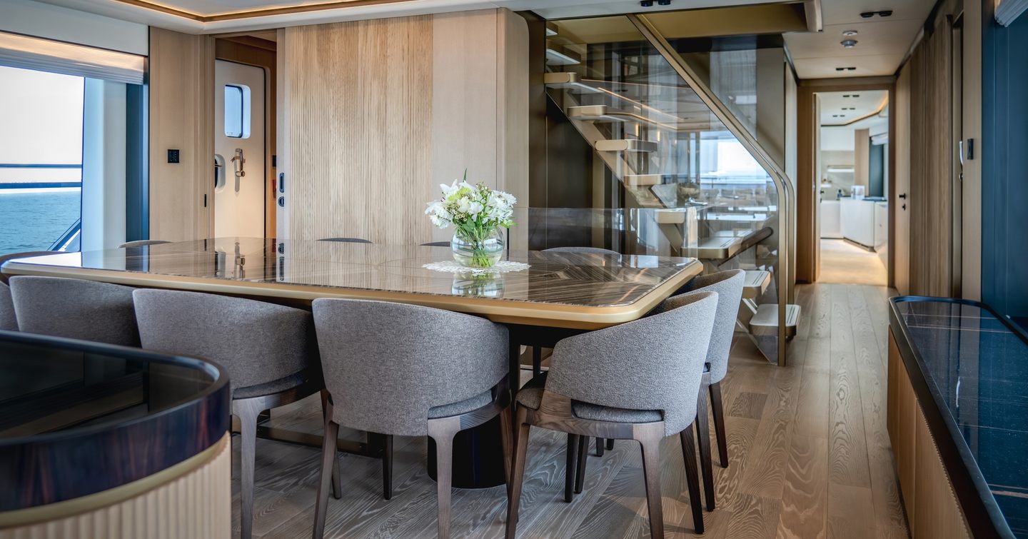 Majesty 112 Terrace Motor Yacht dining area with glass dining table 
