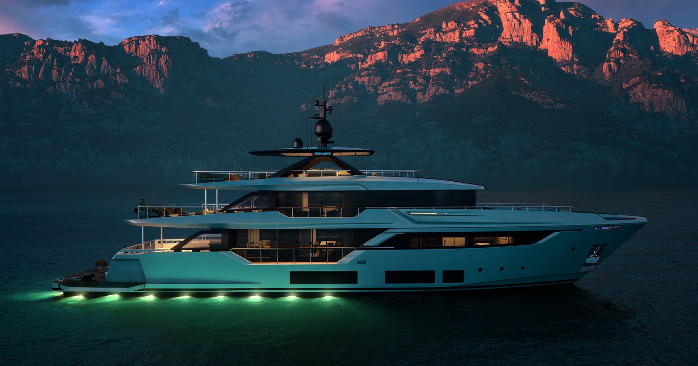 Custom Line Navetta 38 at anchor at dusk showing side profile and underwater lighting along the stern platform