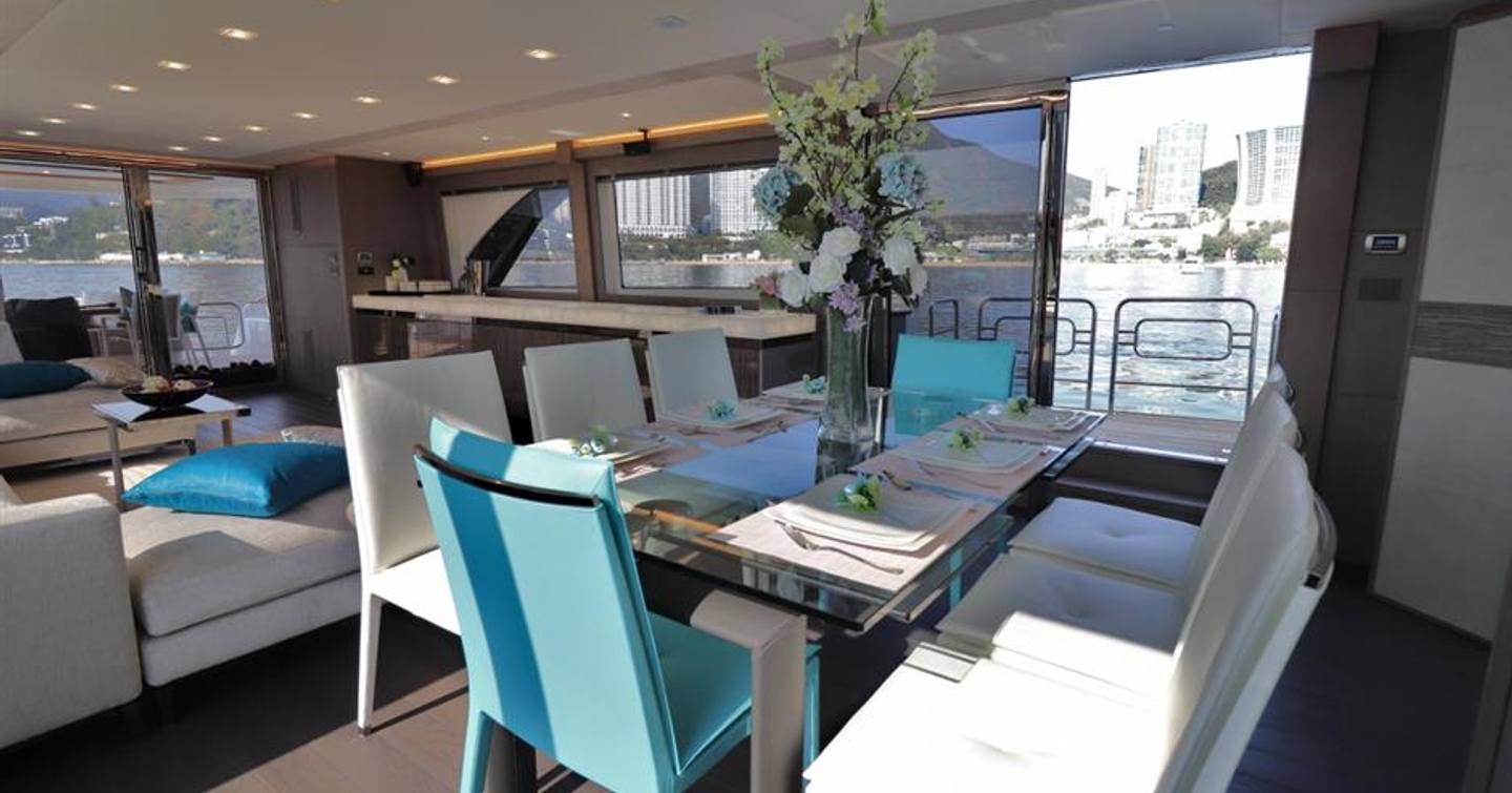 dining table and unfolding balcony in the main salon on board monte carlo yachts' custom mcy 86