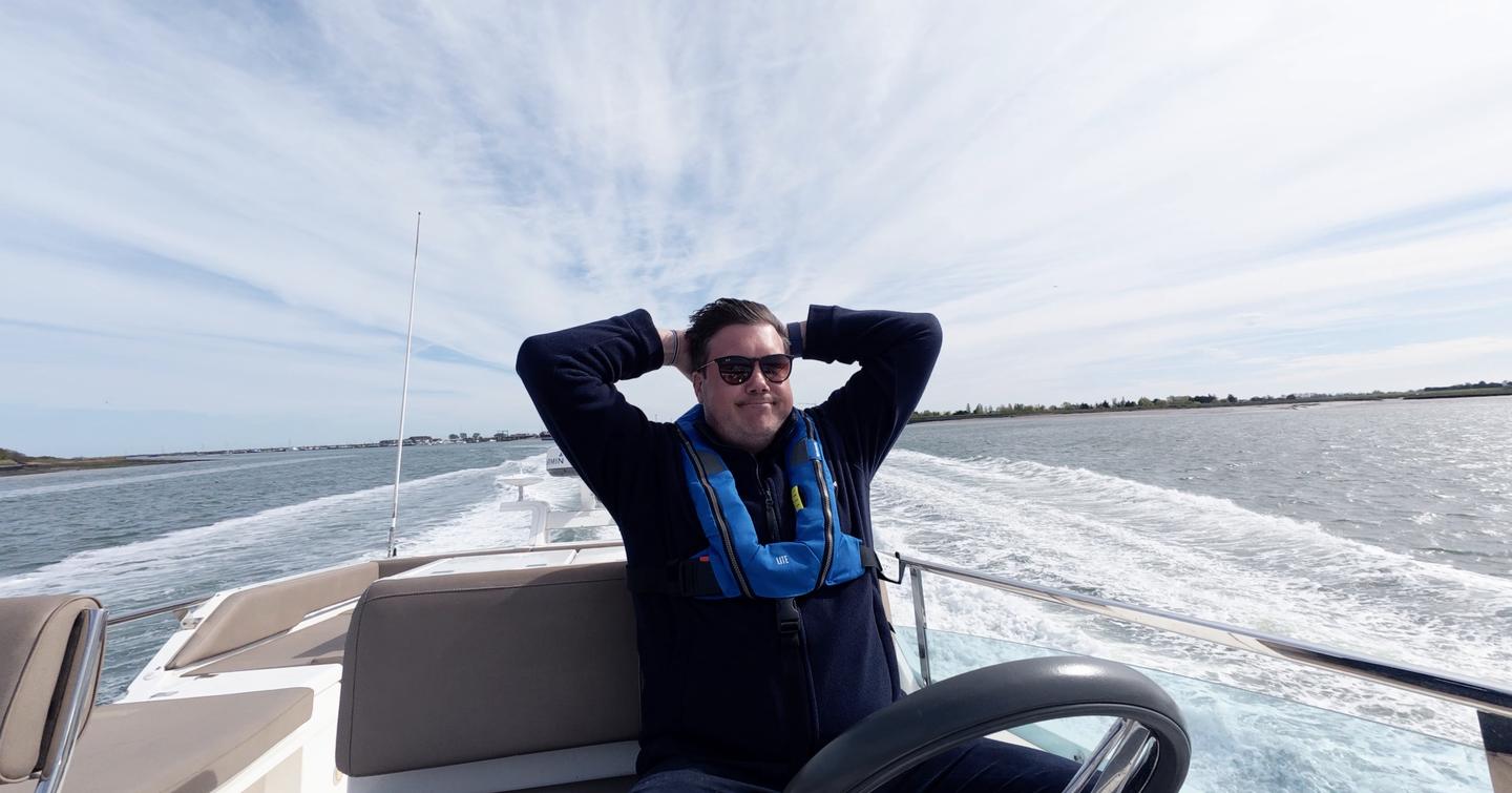 Jack Haines relaxing with his hands behind his head on the Fairline Squadron 42 flybridge during YachtBuyer's £300,000 used boat race.