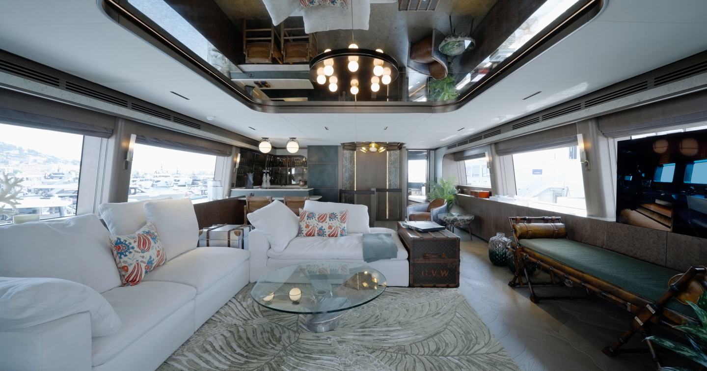 Sirena 118 main saloon with white sofas, mirrored ceiling and panoramic glazing