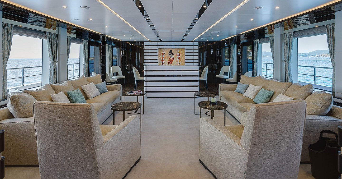 Superyacht Chrimi III's main saloon with L-shaped sofas