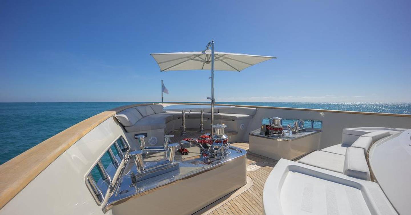 Foredeck on motor yacht Phoenix with seating area and umbrella for shade 