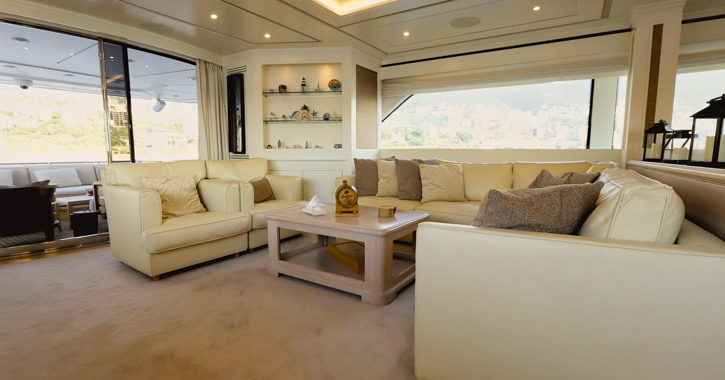 Motor yacht Lady Alina's main saloon with cream sofas and coffee table