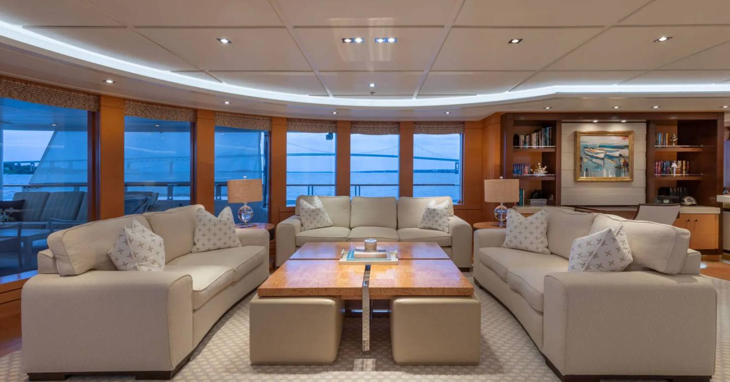 Superyacht Bella Vita main saloon with three white sofas and marbled coffee table 