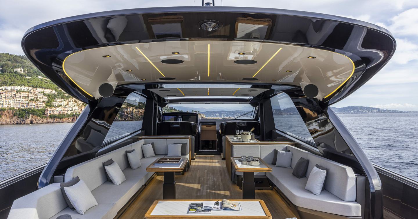 Open Yacht Sexy Me upper deck with shaded seating, helm station and aflresco dining