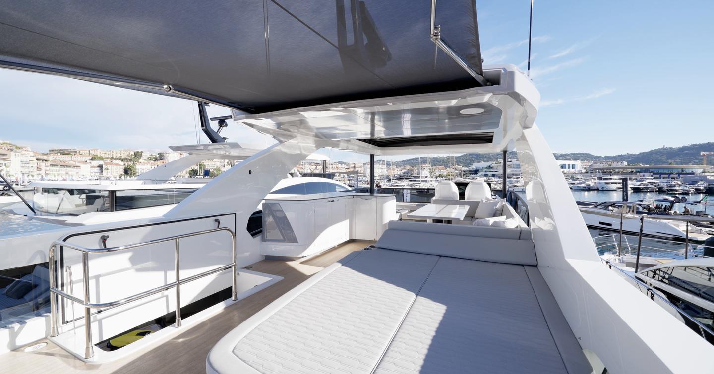 Pearl 73 aft flybridge with fixed sunpad and extended sunshade