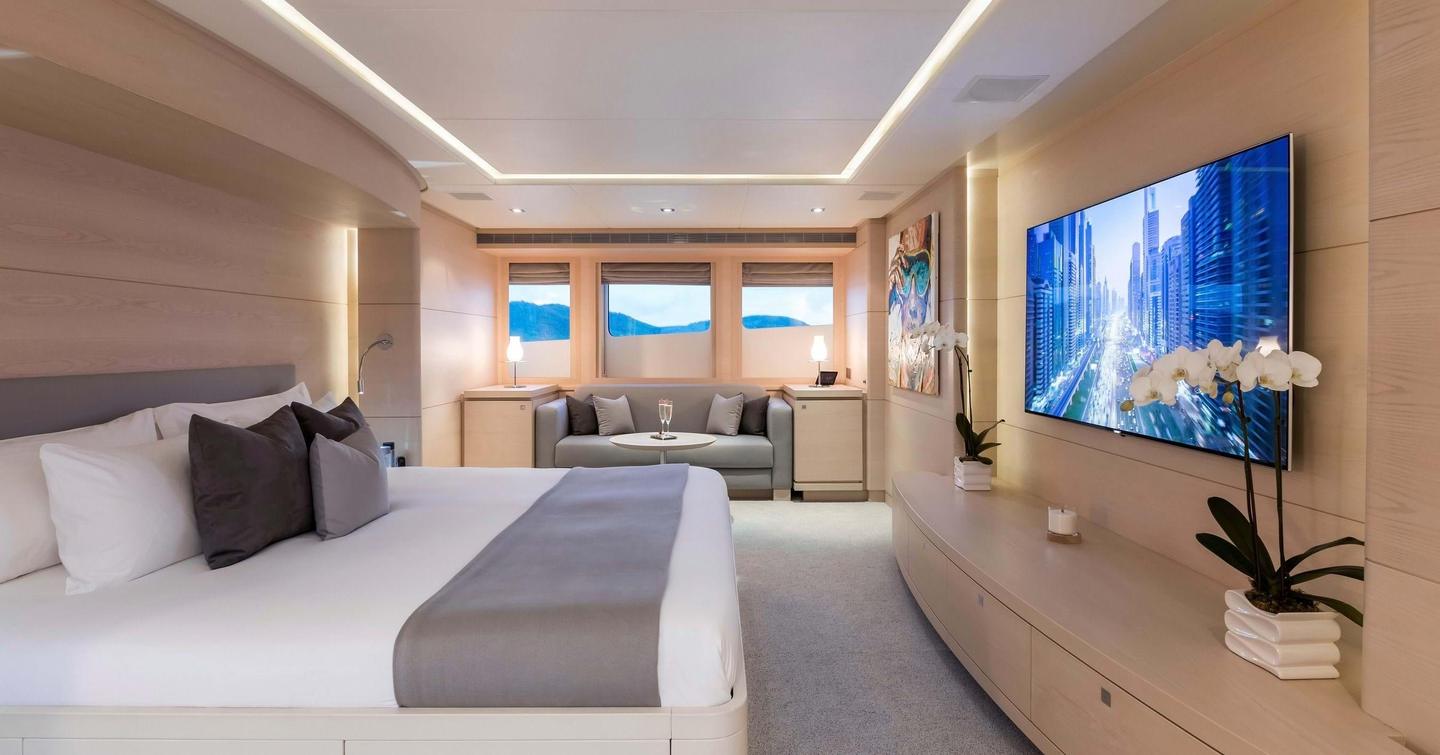 Motor yacht G3 master suite with TV and large windows 