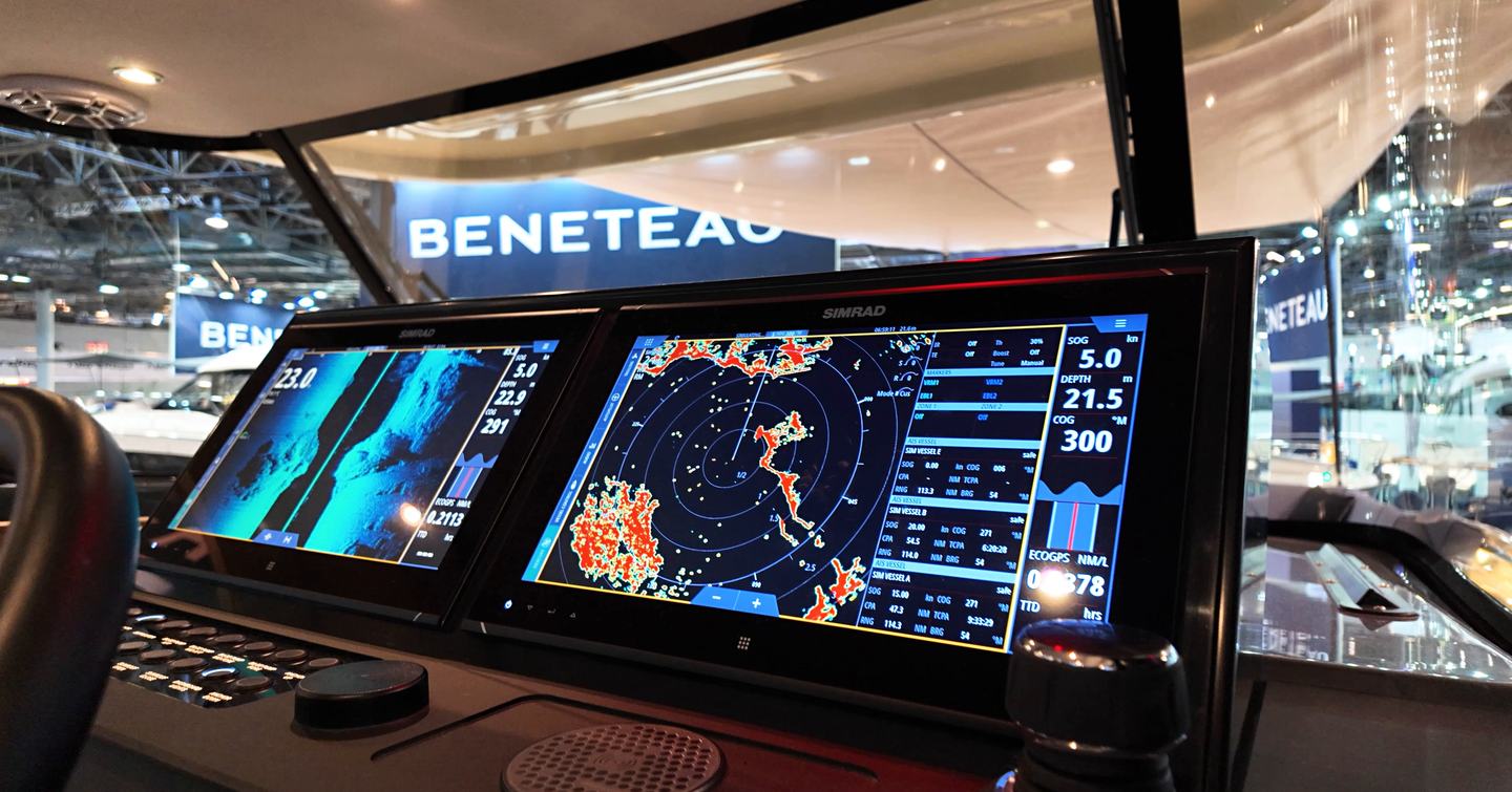 Helm console on the Aiata Sunfinder 50 with twin Simrad multifunction displays showing navigation charts and radar data.
