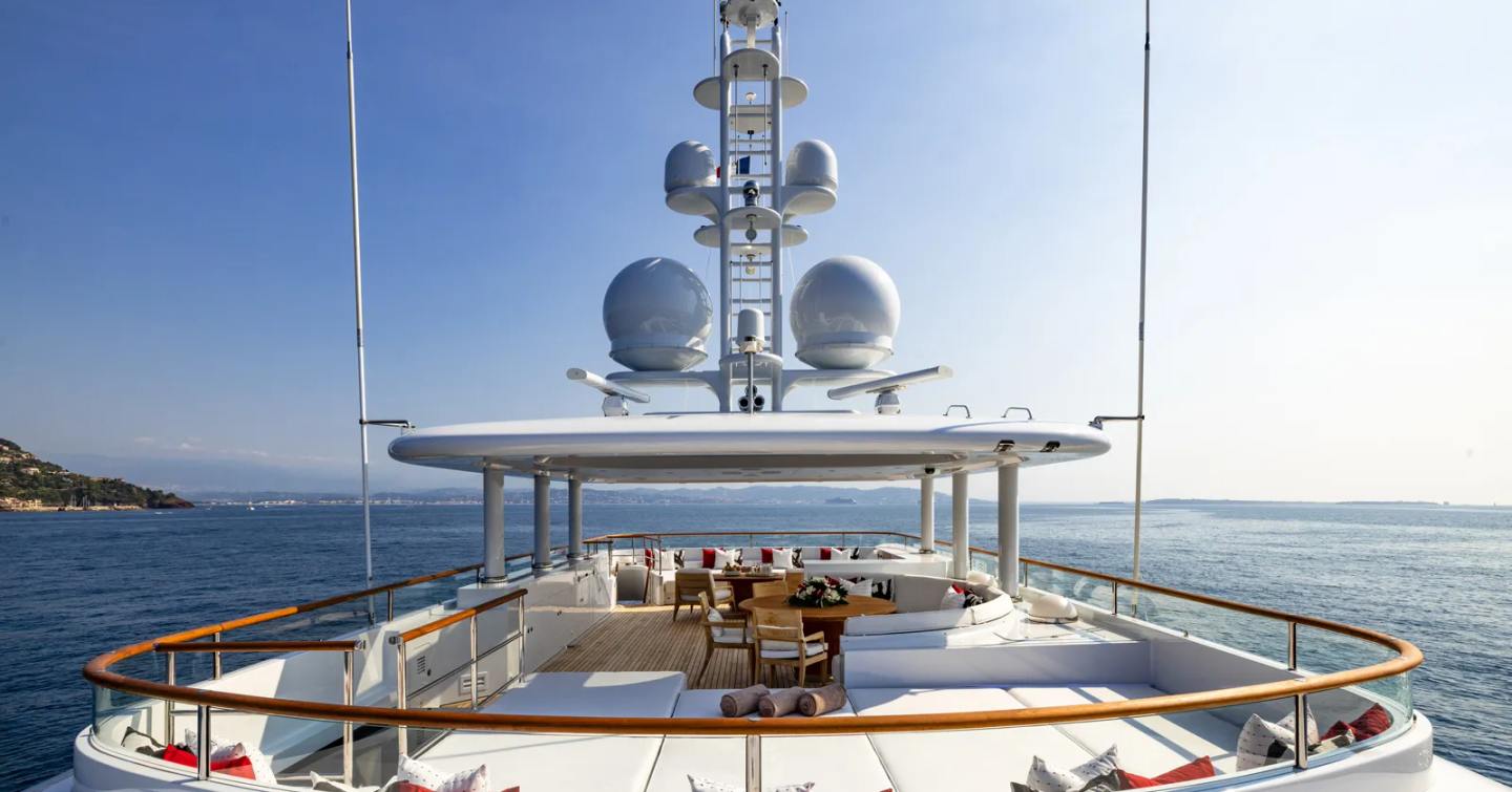 Expedition yacht Bijin sundeck with beige sunpads and shaded alfresco dining