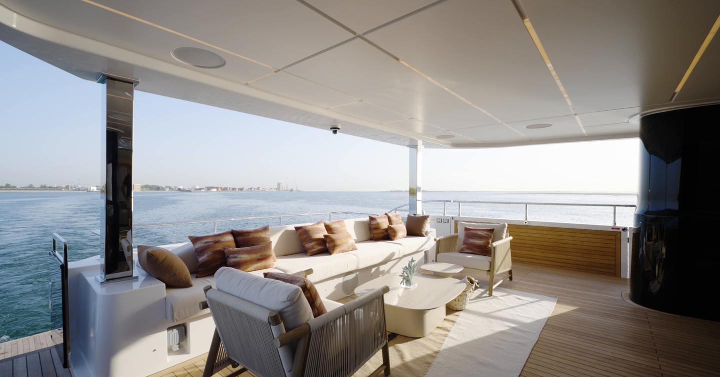 Aft cockpit lounge aboard the Gulf Craft Majesty 100 Terrace with fold-down balconies