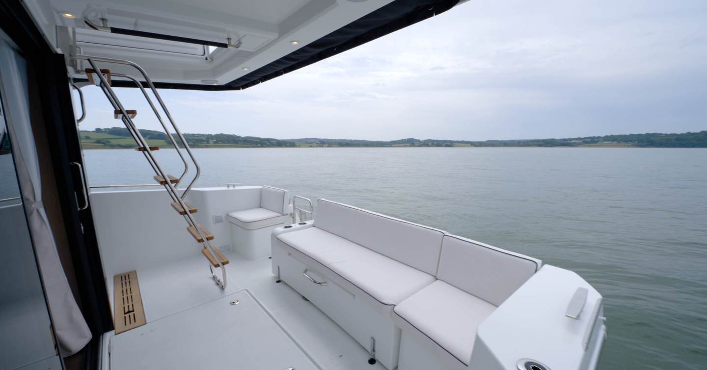 Beneteau Swift Trawler 37 Fly cockpit with sliding bench seat and flybridge access