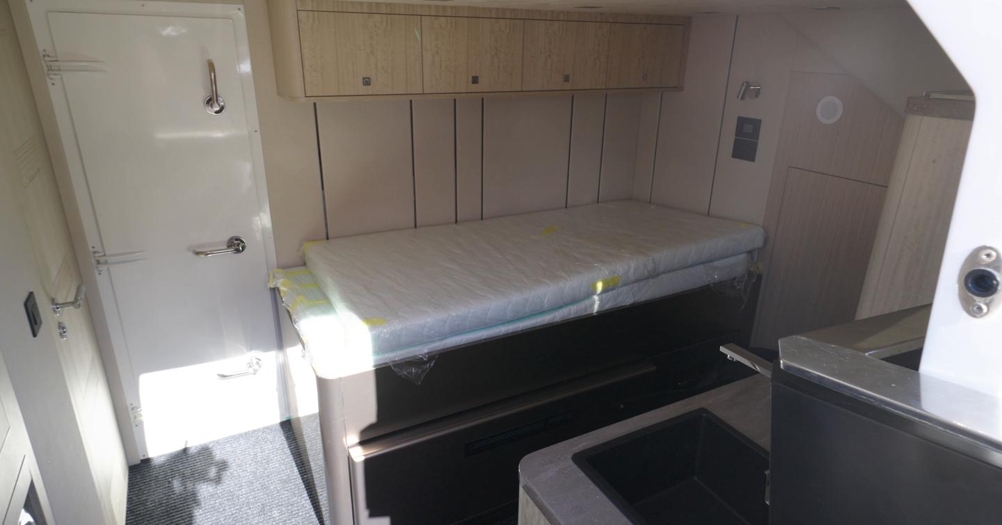 Crew cabin aboard the Galeon 620 Fly with single berth, storage lockers and direct access from the bathing platform.