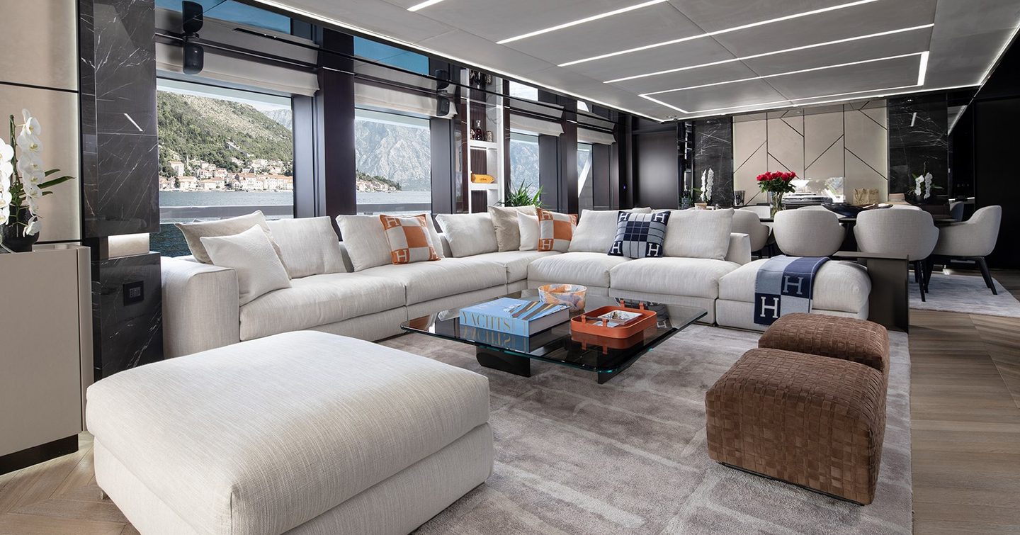 Superyacht Gisa's main saloon with L-shaped sofa and coffee table 