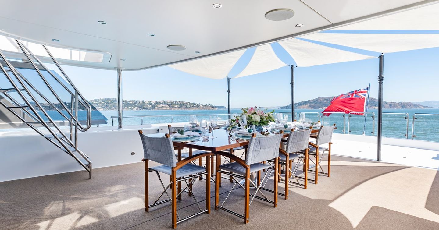 Superyacht Figaro's flybridge with dining table