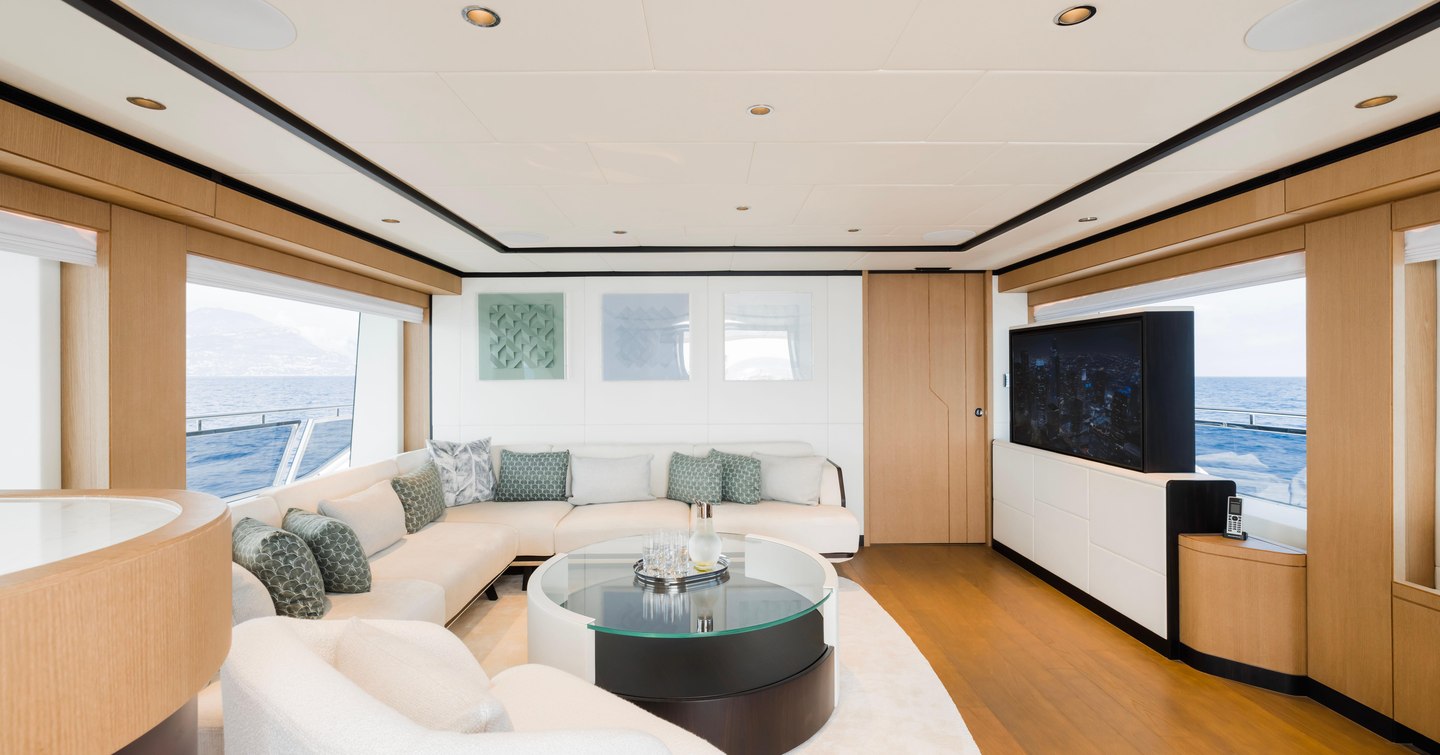 Superyacht Olivia skylounge with white sofas and pop up TV