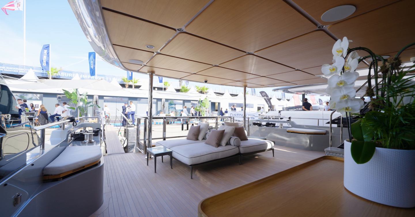 Custom Line Navetta 38 cockpit with flexible seating, covered aft deck and direct connection to beach club
