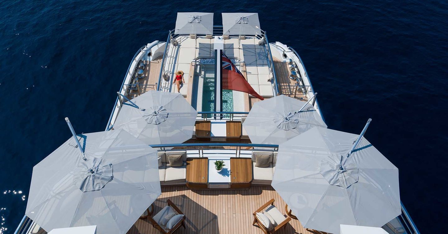 Aerial view of Superyacht DreAMBoat aft decks with shaded seating and infinity pool
