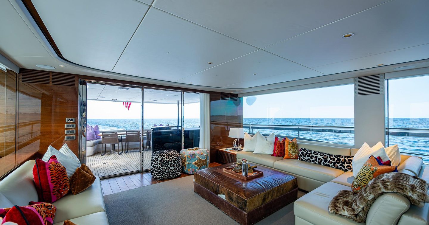 Motor Yacht Splash main saloon with L-shaped white seating 