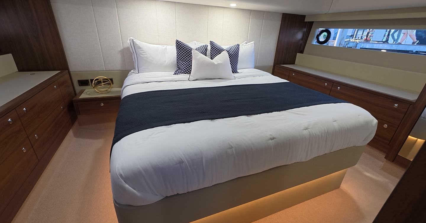 Maritimo M50 owner’s cabin with central double bed, bedside storage and hull window