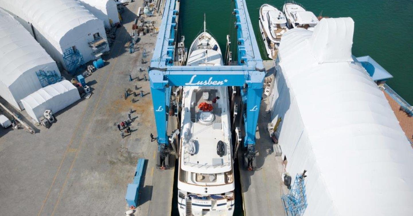 Overhead view looking down on M/Y VIANNE on a crane, being lowered into the water.