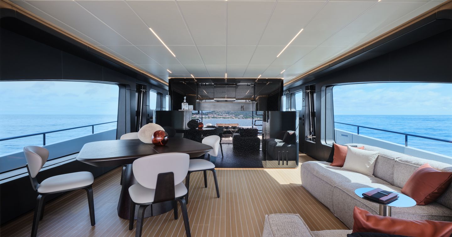 AB Yachts AB 95 motor yacht main saloon with minimalist furniture, dining area and L-shaped seating